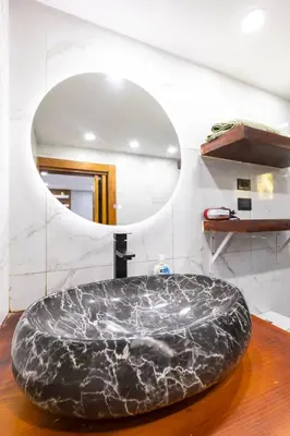 a bathroom with a large marble tub in front of a mirror at nNomad Studio mins from Sirena - Apartment in Sosúa