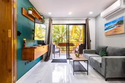 a living room with a couch and a table at nNomad Studio mins from Sirena - Apartment in Sosúa