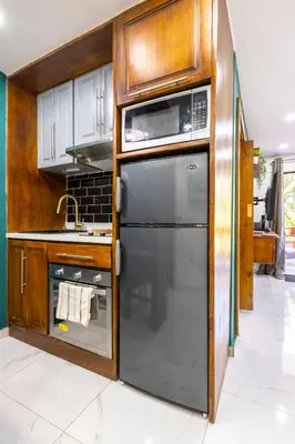 a kitchen with a stainless steel refrigerator and cabinets at nNomad Studio mins from Sirena - Apartment in Sosúa