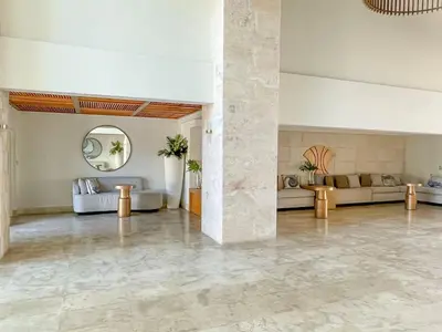 a large living room with couches and a mirror at Costa Del Sol Juan Dolio 2BR Sunset, Beach Front in Juan Dolio