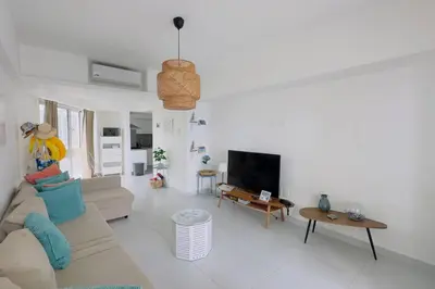 a living room with a couch and a tv at Caribbean Paradise Aquarella 22th in La Puntica de Juan Dolio