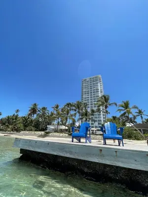 two blue chairs sitting on a dock near the water at Caribbean Paradise Aquarella 22th in La Puntica de Juan Dolio