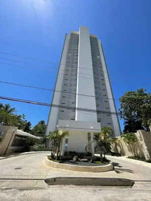 a tall white building with palm trees in front of it at Caribbean Paradise Aquarella 22th in La Puntica de Juan Dolio