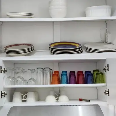 a white pantry with plates and dishes on shelves at KERY-OASIS 2bdr with pool close to the Beach in Las Terrenas
