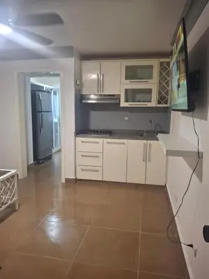 a kitchen with white cabinets and a refrigerator at Amazing condo in the hearth of Sosua PERFECT LOCATION in Sosúa