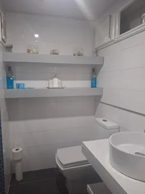 a white bathroom with a toilet and a sink at Amazing condo in the hearth of Sosua PERFECT LOCATION in Sosúa