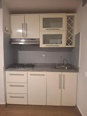 a kitchen with white cabinets and a sink at Amazing condo in the hearth of Sosua PERFECT LOCATION in Sosúa