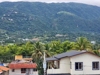 a city with a mountain in the background at Remanso 1 in Jarabacoa