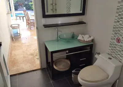 a bathroom with a sink and a toilet at Family Villa at Las Galeras, Samaná in Las Galeras