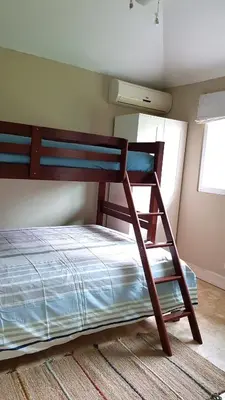 a bedroom with a bunk bed with a ladder at Family Villa at Las Galeras, Samaná in Las Galeras