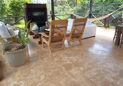 a patio with a couch and a table and chairs at Family Villa at Las Galeras, Samaná in Las Galeras