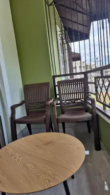 two chairs and a table in a room with a window at Family Relaxation in San Isidro