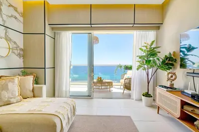 a bedroom with a bed and a view of the ocean at Luxurious Caribbean Aquarella 10th in La Puntica de Juan Dolio