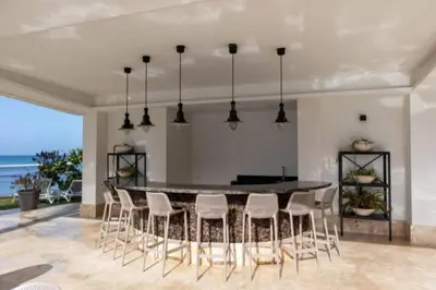 a kitchen with a table and chairs and the ocean at Aquarella Caribbean Blue Summer Special GateAway in La Puntica de Juan Dolio