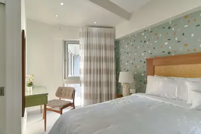 a bedroom with a bed and a desk and a chair at Aquarella Caribbean Blue Summer Special GateAway in La Puntica de Juan Dolio