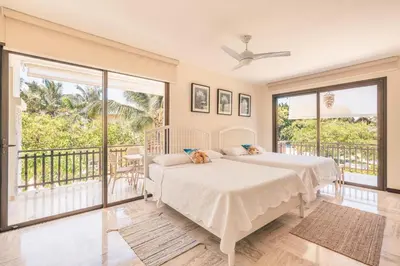 two beds in a bedroom with a balcony at Apartment with 2bedrooms in Portillo Residences in Las Terrenas