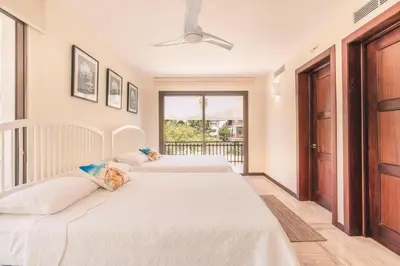 two beds in a room with a balcony at Apartment with 2bedrooms in Portillo Residences in Las Terrenas