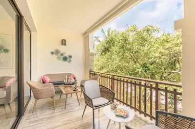 a room with a balcony with chairs and tables at Apartment with 2bedrooms in Portillo Residences in Las Terrenas