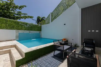 a swimming pool in the backyard of a house at Perla 8- Exclusiva Moderna Villa 4 Habitaciones y Piscina in Sosúa