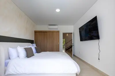a bedroom with a large white bed in a room at PERLA I -Modern Private Villa - 4 Bedrooms with Pool in Sosúa