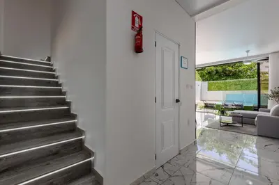 a staircase in a house with a door at PERLA I -Modern Private Villa - 4 Bedrooms with Pool in Sosúa