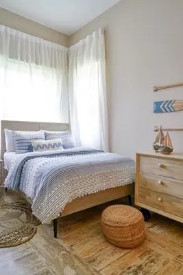a bedroom with a bed and a dresser and a window at ®{The~Beach~View} @PlayaBonita BeachfrontPool in Las Terrenas