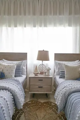 a bedroom with two beds and a table with a lamp at ®{The~Beach~View} @PlayaBonita BeachfrontPool in Las Terrenas