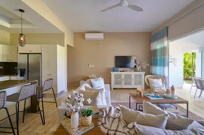 a living room with a couch and a table at ®{The~Beach~View} @PlayaBonita BeachfrontPool in Las Terrenas