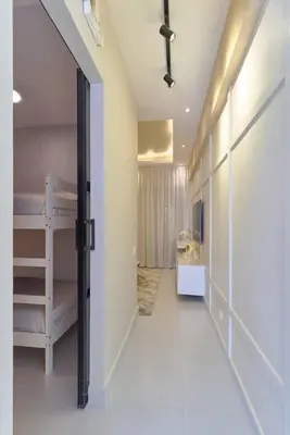 a hallway with a room with bunk beds and a door at Aquarella Caribbean Paradise Playa Juan Dolio in La Puntica de Juan Dolio