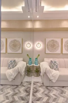 a living room with two white couches and two tables at Aquarella Caribbean Paradise Playa Juan Dolio in La Puntica de Juan Dolio
