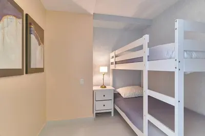 a bedroom with a bunk bed and a desk at Aquarella Caribbean Paradise Playa Juan Dolio in La Puntica de Juan Dolio