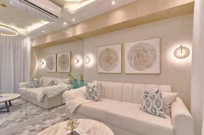 a living room with two white couches and a mirror at Aquarella Caribbean Paradise Playa Juan Dolio in La Puntica de Juan Dolio