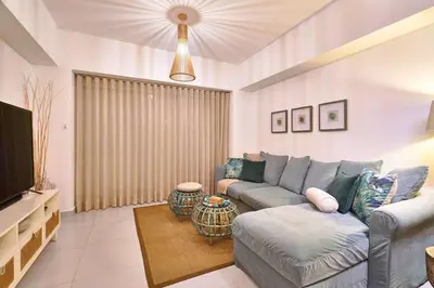 a living room with a couch and a tv at Aquarella Deluxe Caribbean Paradise in La Puntica de Juan Dolio