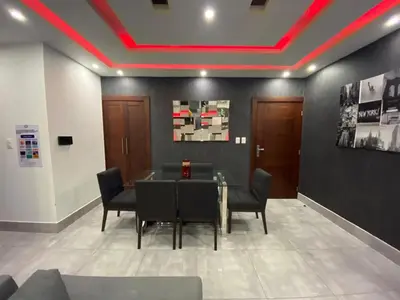 a dining room with a table and chairs and a red ceiling at Soja 11 in Santiago de los Caballeros