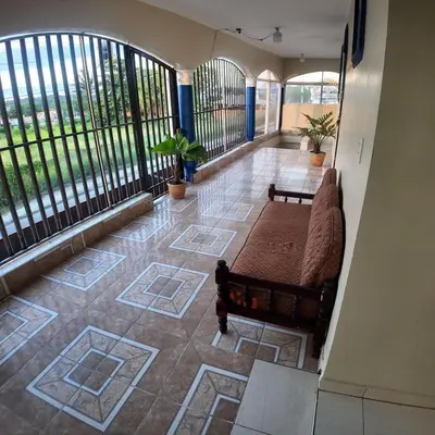 a balcony with a couch on a floor with windows at Apartamento Mariela 4 in San Felipe de Puerto Plata