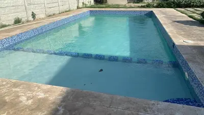 a swimming pool with blue water in a yard at The Ocean Romana in La Romana