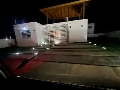 a house with lights on the roof at night at The Ocean Romana in La Romana
