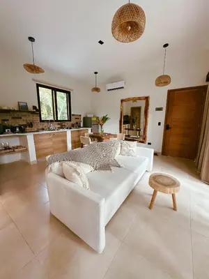 a living room with a white couch and a table at Casa Caona in El Valle