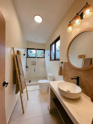 a bathroom with a sink and a toilet and a mirror at Casa Caona in El Valle