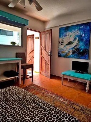 a room with a desk and a painting on the wall at Chilvers Seaside Studio 202 in Cabarete