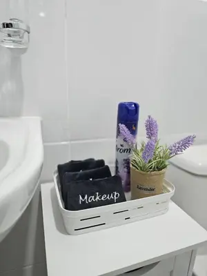 a bathroom with a sink and a white table with a box of makeup at Modern 3BR Apmt Near Airport & Beach in San Isidro