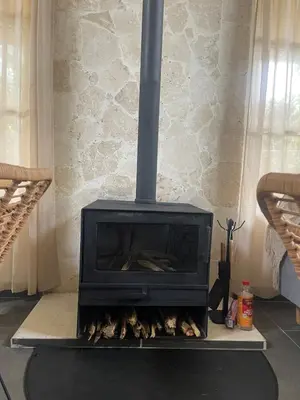 a fireplace with a stove in a living room at Villa Linda in Polo