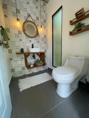 a bathroom with a toilet and a sink at Villa Linda in Polo