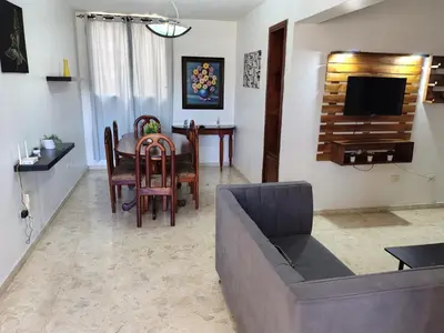 a living room with a couch and a table at Exclusive Apartment Free WiFi and Parking in Santo Domingo