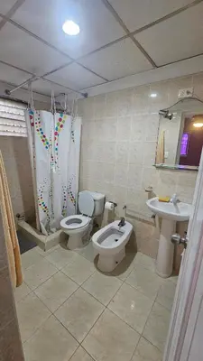 a bathroom with two toilets and a sink at Apartment 150m from the beach with pool in Boca Chica