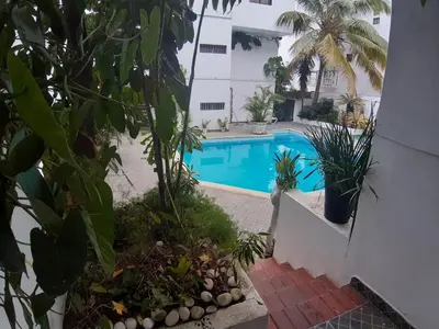 a view of a swimming pool in a house with plants at Apartment 150m from the beach with pool in Boca Chica