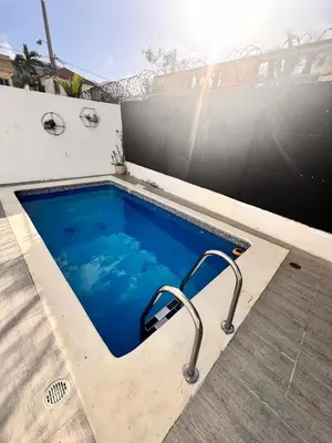 a small swimming pool with a metal rail around it at Popsy Villa 3 Bedrooms with Pool in Puerto Plata