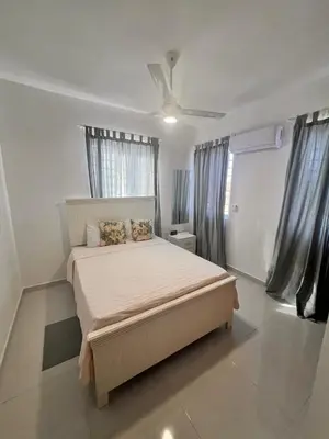 a bedroom with a bed and a ceiling fan at Popsy Villa 3 Bedrooms with Pool in Puerto Plata