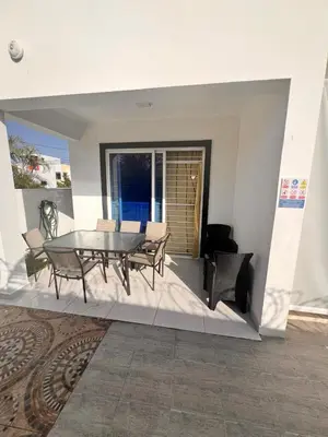a dining room with a table and chairs on a patio at Popsy Villa 3 Bedrooms with Pool in Puerto Plata