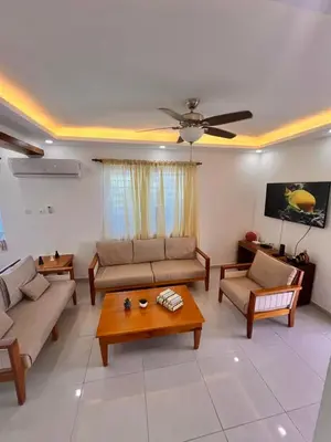 a living room with couches and a coffee table at Popsy Villa 3 Bedrooms with Pool in Puerto Plata